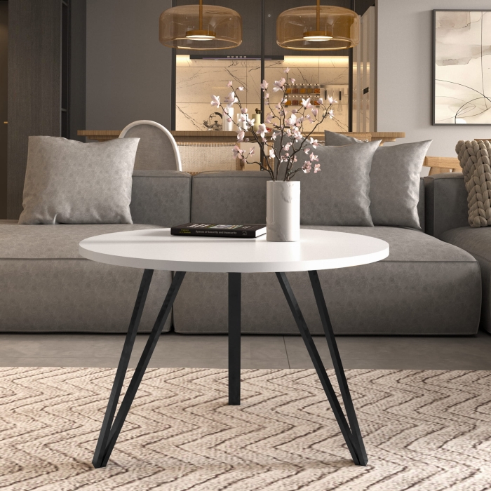 Stolik kawowy na potrójnych czarnych nogach, blat okrągły biały. Showroom